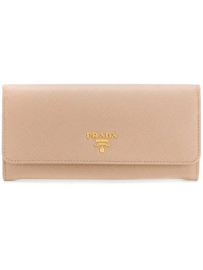 Shop Prada Saffiano Foldover Wallet - Neutrals