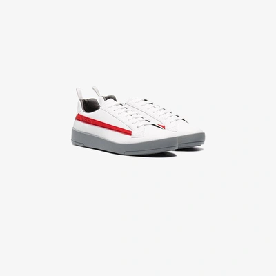 Shop Prada Logo Embossed Low-top Sneakers In White