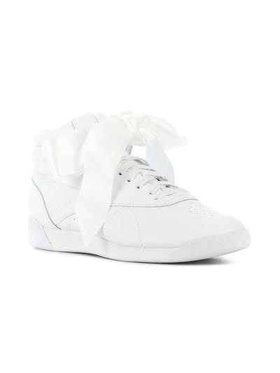 Shop Reebok Freestyle Hi Satin Bow Sneakers In White