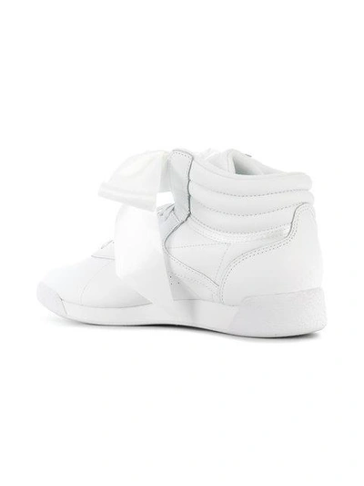 Shop Reebok Freestyle Hi Satin Bow Sneakers In White