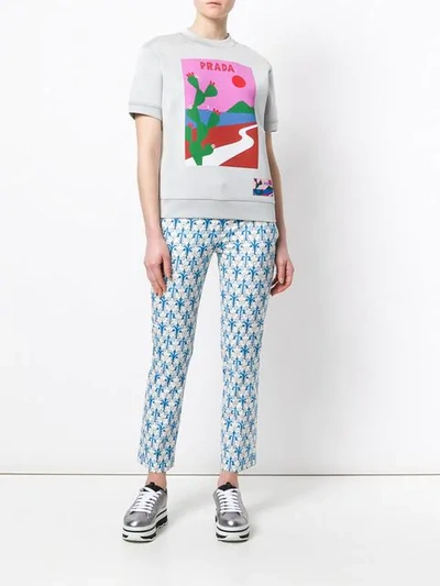 Shop Prada Floral Print Trousers In Blue