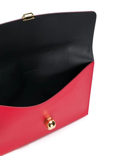 Shop Alexander Mcqueen Skull Charm Clutch - Red