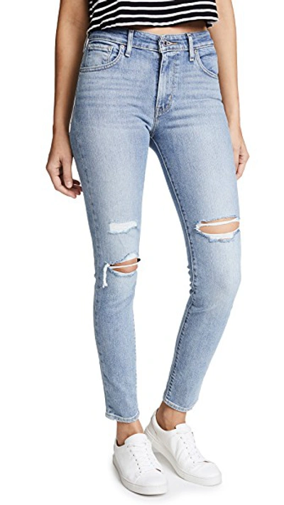 Shop Levi's 721 High Rise Skinny Jeans In Worn & Torn