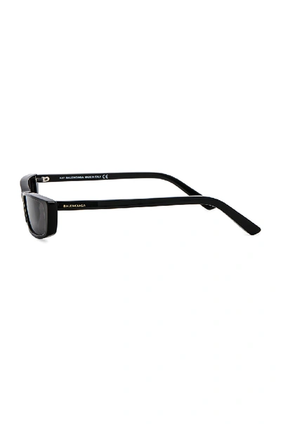 Shop Balenciaga Narrow Cat Eye Sunglasses In Shiny Black & Smoke Lenses