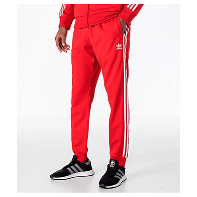 Shop Adidas Originals Men's Originals Adicolor Superstar Track Pants, Red