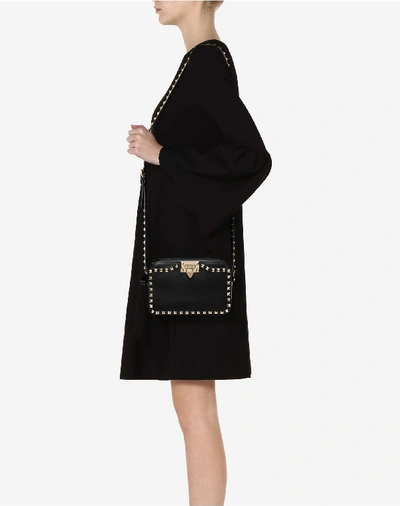 Shop Valentino Small Rockstud Crossbody Bag In Black