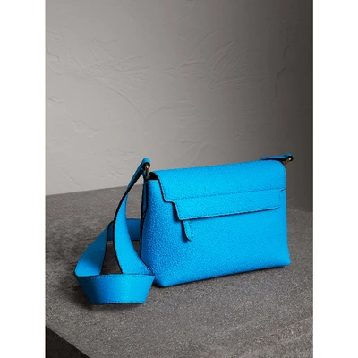 Shop Burberry Small Embossed Neon Leather Messenger Bag In Neon Blue