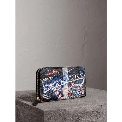 Shop Burberry Doodle Print Coated Canvas Ziparound Wallet In Black