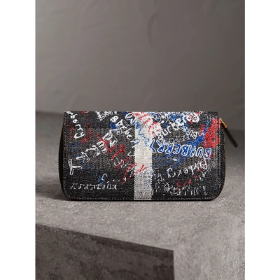 Shop Burberry Doodle Print Coated Canvas Ziparound Wallet In Black
