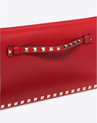 Shop Valentino Garavani Medium Rockstud Clutch In Rosso