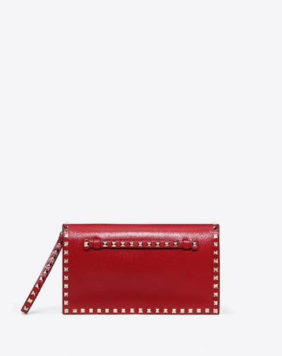 Shop Valentino Garavani Medium Rockstud Clutch In Rosso