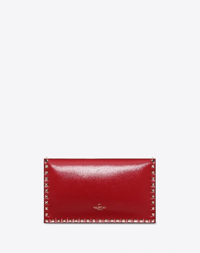 Shop Valentino Garavani Medium Rockstud Clutch In Rosso