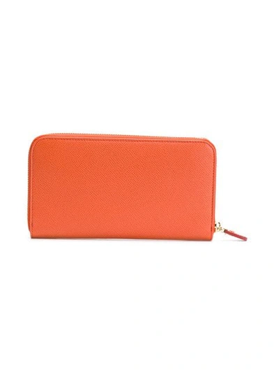 Shop Ferragamo Gancini Zipped Wallet In Yellow & Orange