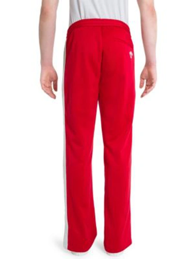 Shop Versace Cotton-blend Drawstring Sweatpants In Red