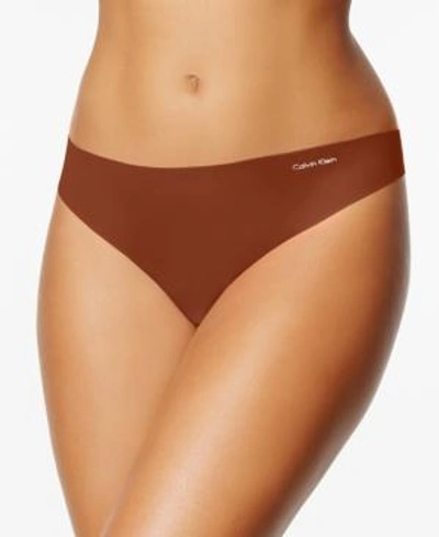 Shop Calvin Klein Women's Invisibles Thong Underwear D3428 In Cinnamon
