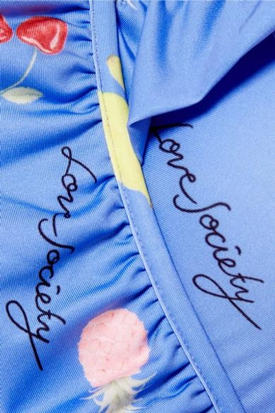Shop Ganni Dexies Ruffled Printed Halterneck Swimsuit In Light Blue