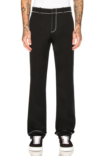 Shop Givenchy Contrast Stitch Trousers In Black