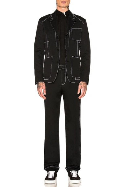 Shop Givenchy Contrast Stitch Trousers In Black