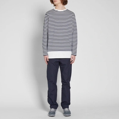 Shop Uniform Experiment Long Sleeve Fake Hem Border Tee In Blue