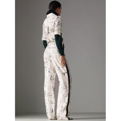 Shop Burberry Landmark Print Silk Jumpsuit In Off White/black
