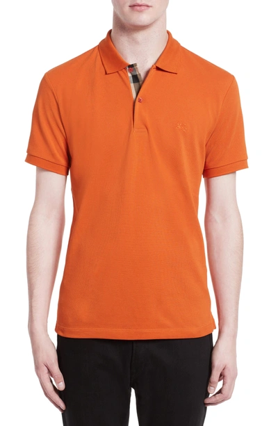 Shop Burberry Pique Polo In Clementine