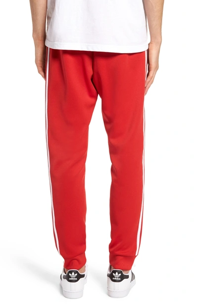 Shop Adidas Originals Track Pants In Scarlet