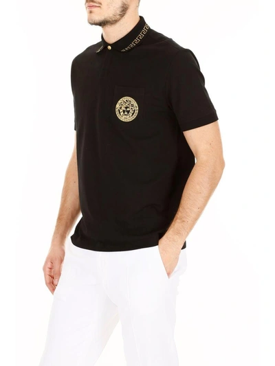 Shop Versace Embroidered Polo Shirt In Nero-oronero