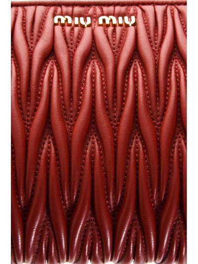 Shop Miu Miu Matelasse Leather Clutch In Fire