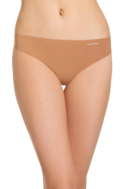Shop Calvin Klein 'invisibles' Thong In Bronzed
