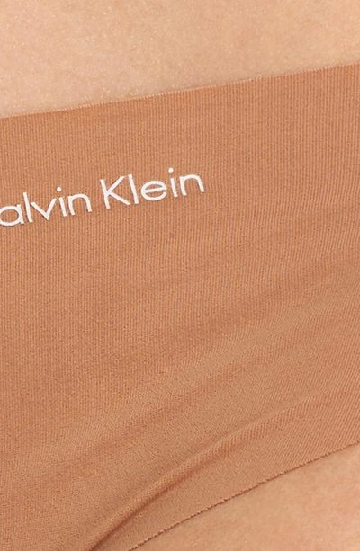 Shop Calvin Klein 'invisibles' Thong In Bronzed