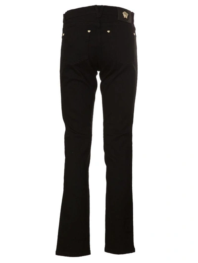 Shop Versace Medusa Stud Cropped Jeans In Nero