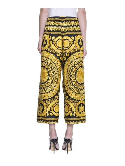 Shop Versace Cropped Silk Pants In Nero