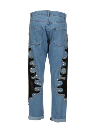 Shop Moschino Studded Jeans In Denim