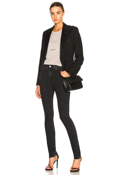 Shop Saint Laurent Medium Rise Skinny Jeans In Black