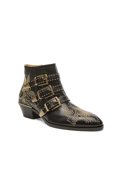 Shop Chloé Susanna Leather Studded Booties In Black & Gold