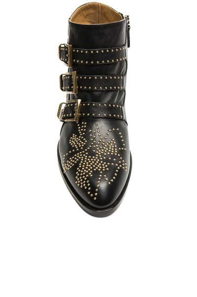 Shop Chloé Susanna Leather Studded Booties In Black & Gold