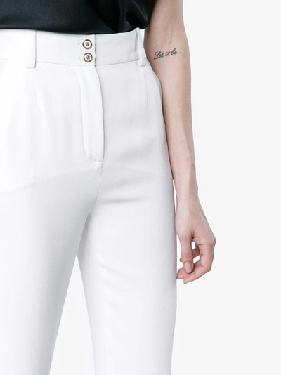 Shop Versace Mid Rise Slim Leg Trousers In White