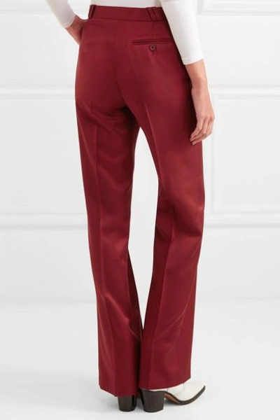 Shop Acne Studios Tohny Pleated Satin-twill Flared Pants In Burgundy
