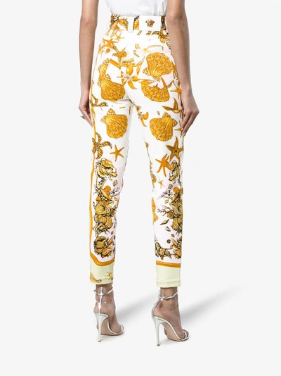 Shop Versace High Rise Jeans With Marine Print In Yellow