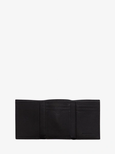 Shop Alexander Mcqueen Studded Trifold Wallet In Black