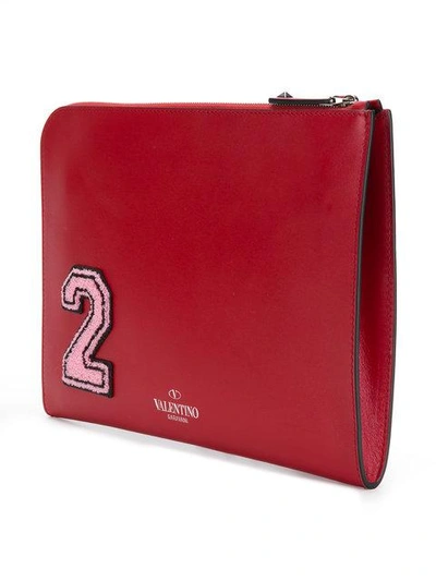 Shop Valentino Rockstud Appliqué Clutch In Red