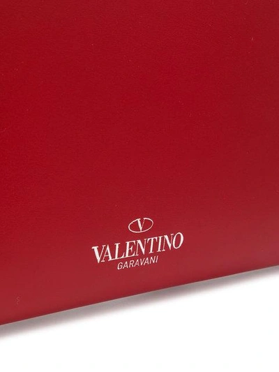 Shop Valentino Rockstud Appliqué Clutch In Red