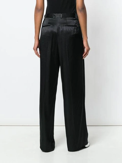 Shop Givenchy High-waisted Flared Trousers - Black