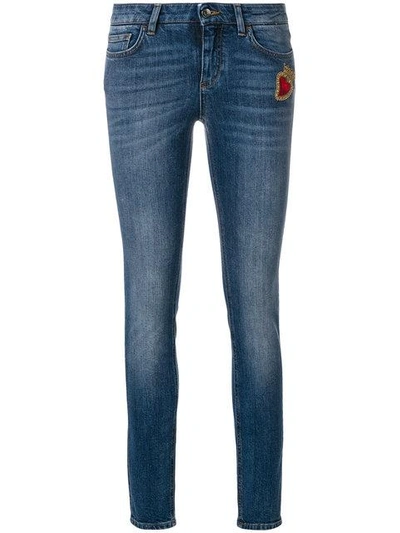 skinny jeans with Sacred Heart patch