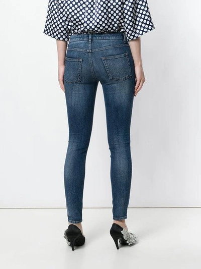 skinny jeans with Sacred Heart patch