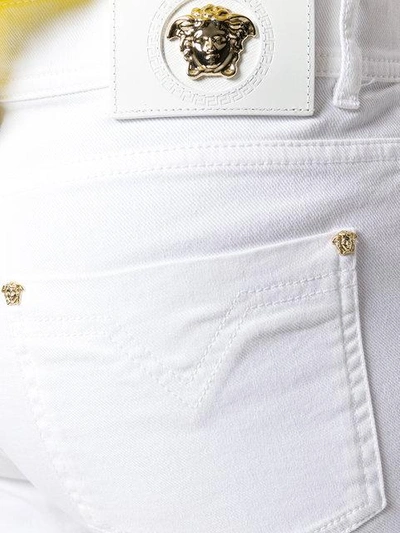 Shop Versace Slim Fit Jeans - White