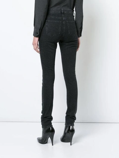 Shop Saint Laurent Faded Skinny Jeans In Black