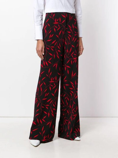 Shop Diane Von Furstenberg Leaf Print Flared Trousers In Black