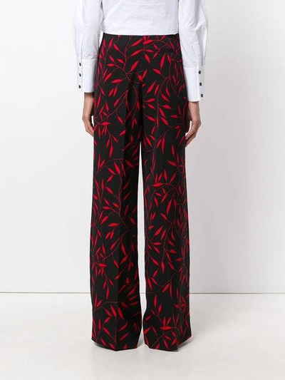 Shop Diane Von Furstenberg Leaf Print Flared Trousers In Black