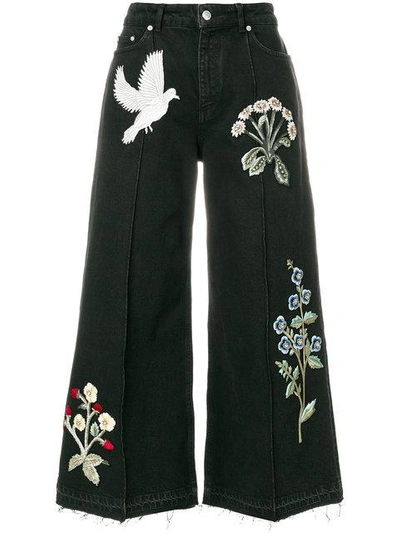 Shop Alexander Mcqueen Embroidered Patch Wide Leg Jeans - Black